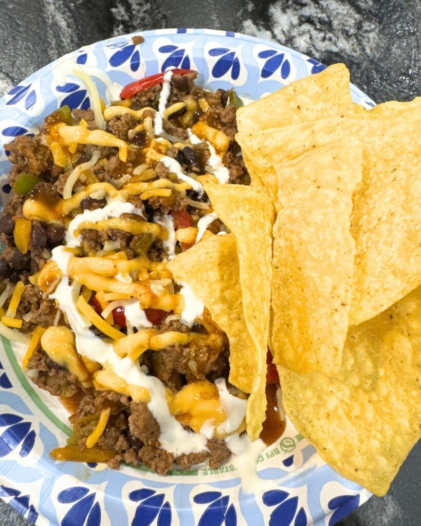 Ground beef taco bowl topped with cheese and tortilla chips