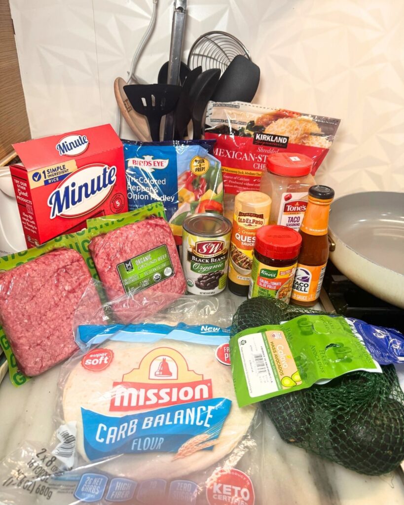 Ingredients for ground beef taco bowls arranged on a kitchen counter