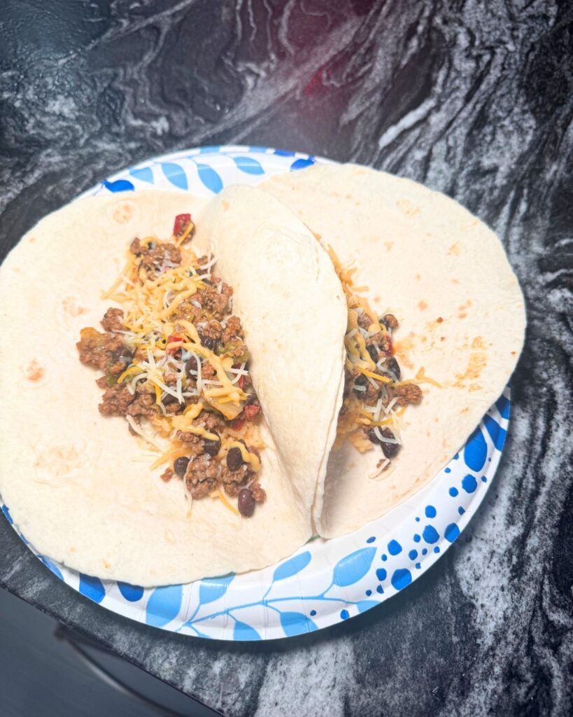 Ground beef taco served in a soft tortilla