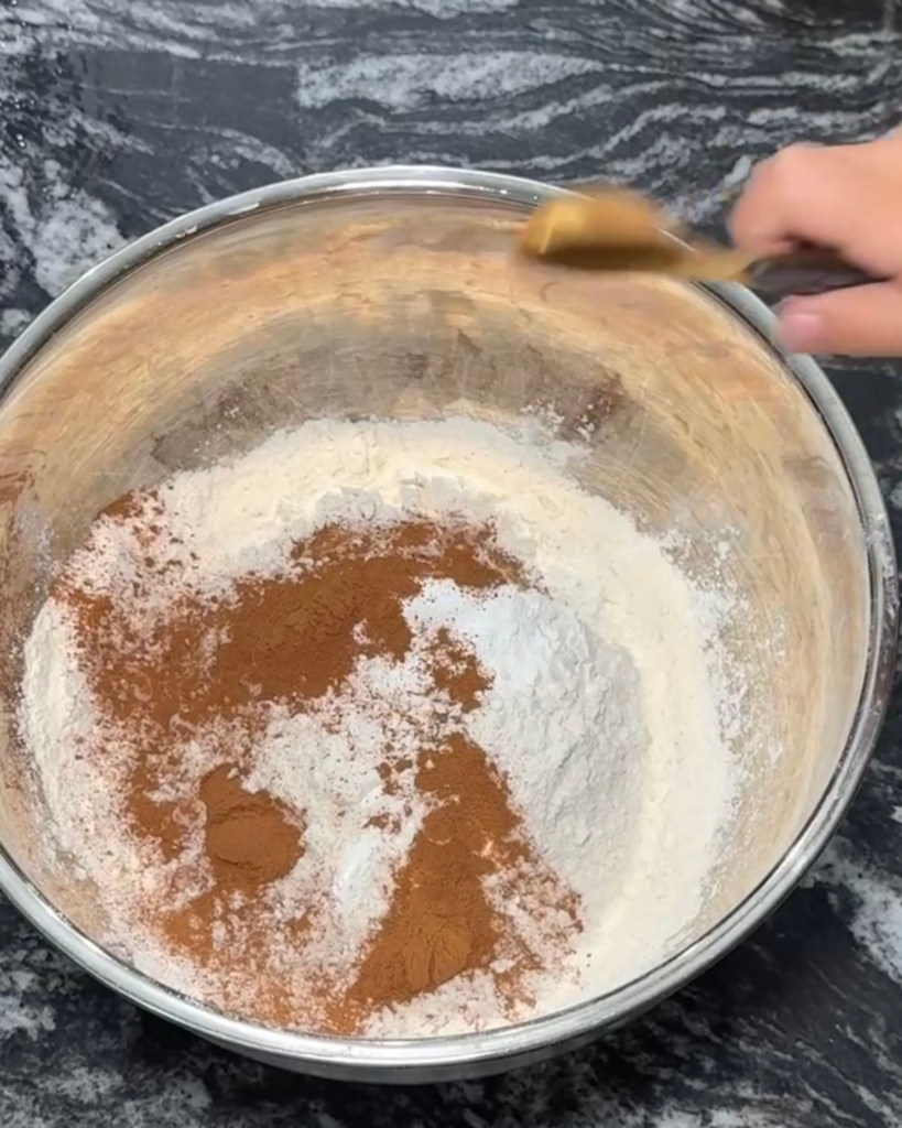 Flour, cinnamon and pumpkin pie spice mixed together for pumpkin chocolate chip cookies