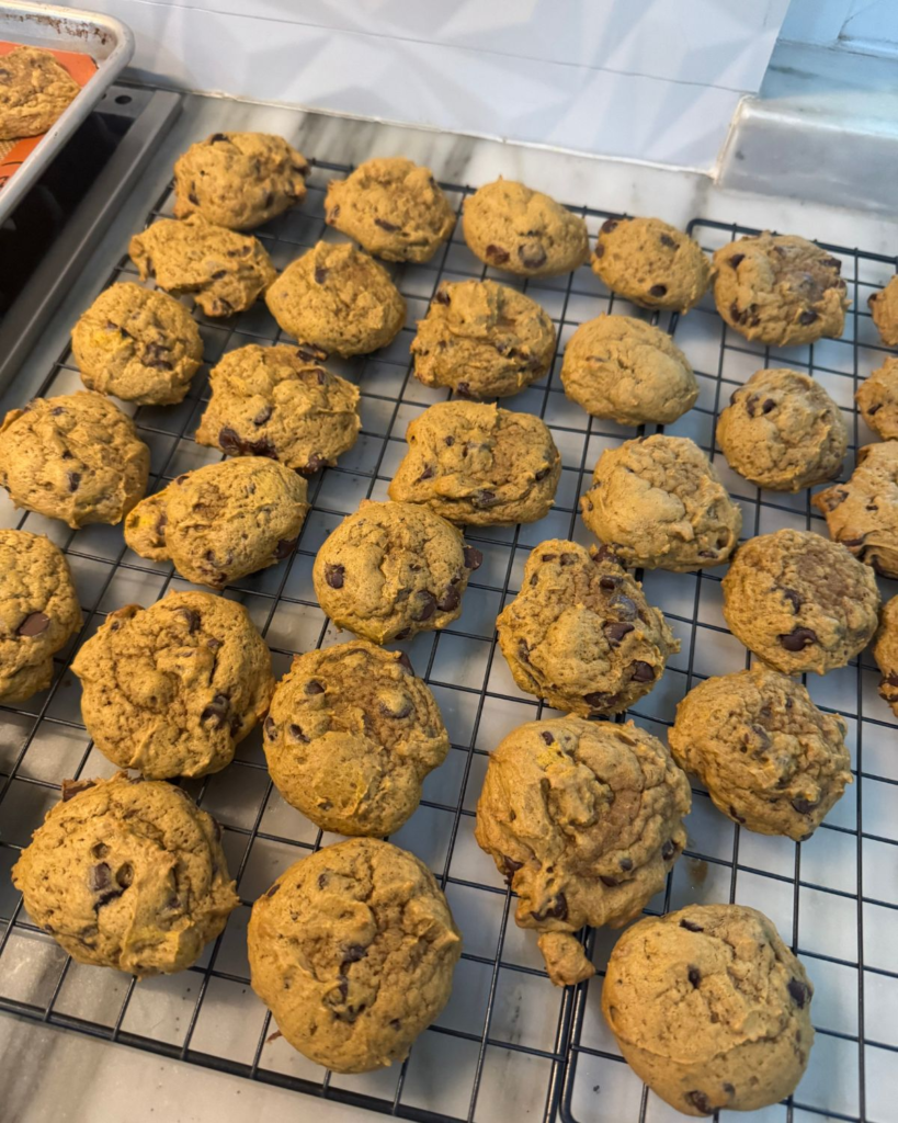 Freshly baked pumpkin chocolate chip cookies cooling on a wire rack
