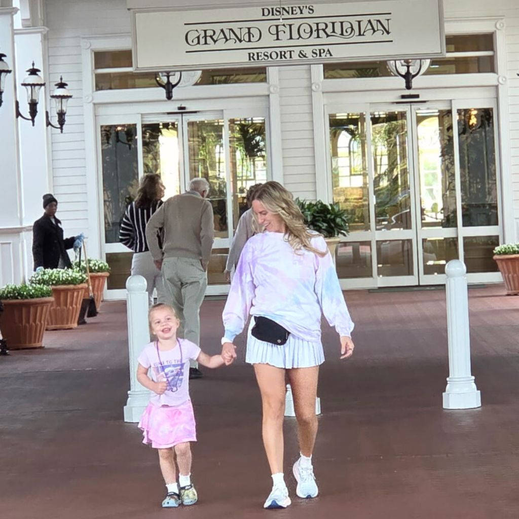 Mom wearing athletic skirt and spirit jersey at Disney World