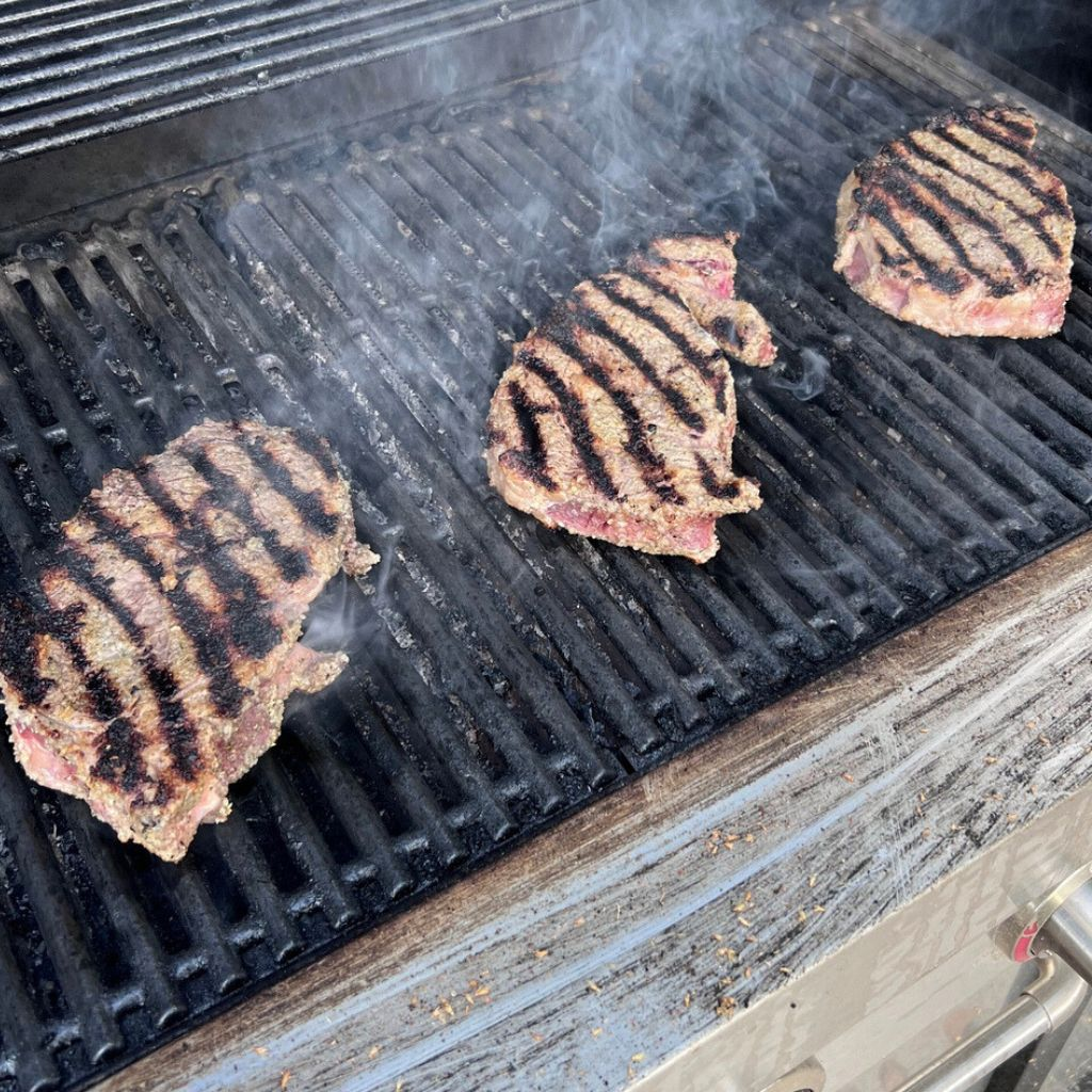 Steaks grilling for our simple Sunday dinner routine