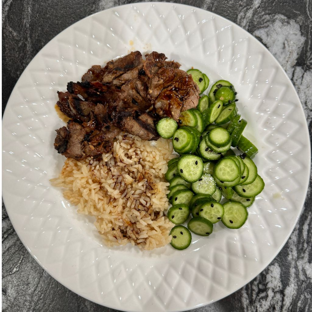 High-protein steak and rice bowl with cucumbers as part of a weekly dinner prep system