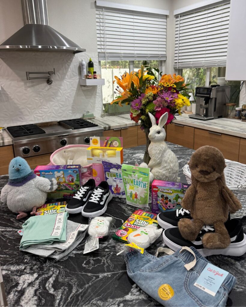 Easter basket fillers for girls including YumEarth gummies, crayons, kids sneakers, plush toys, and small LEGO sets.