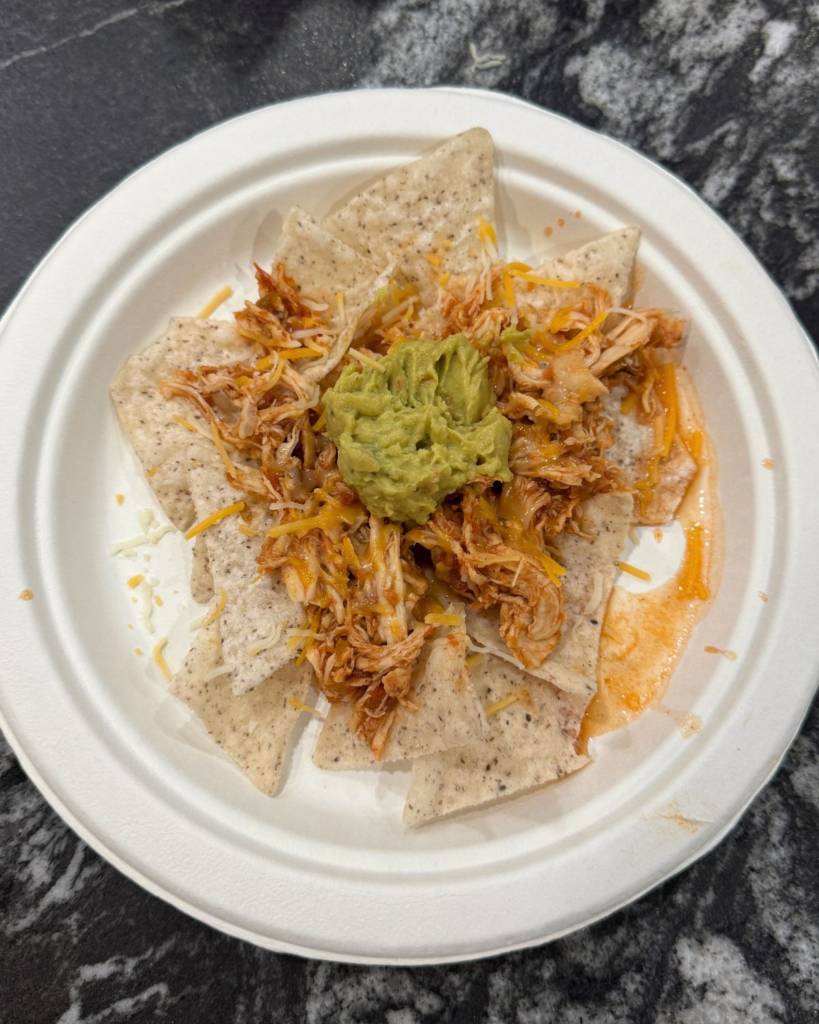 salsa chicken nachos with tortilla chips cheese and guacamole