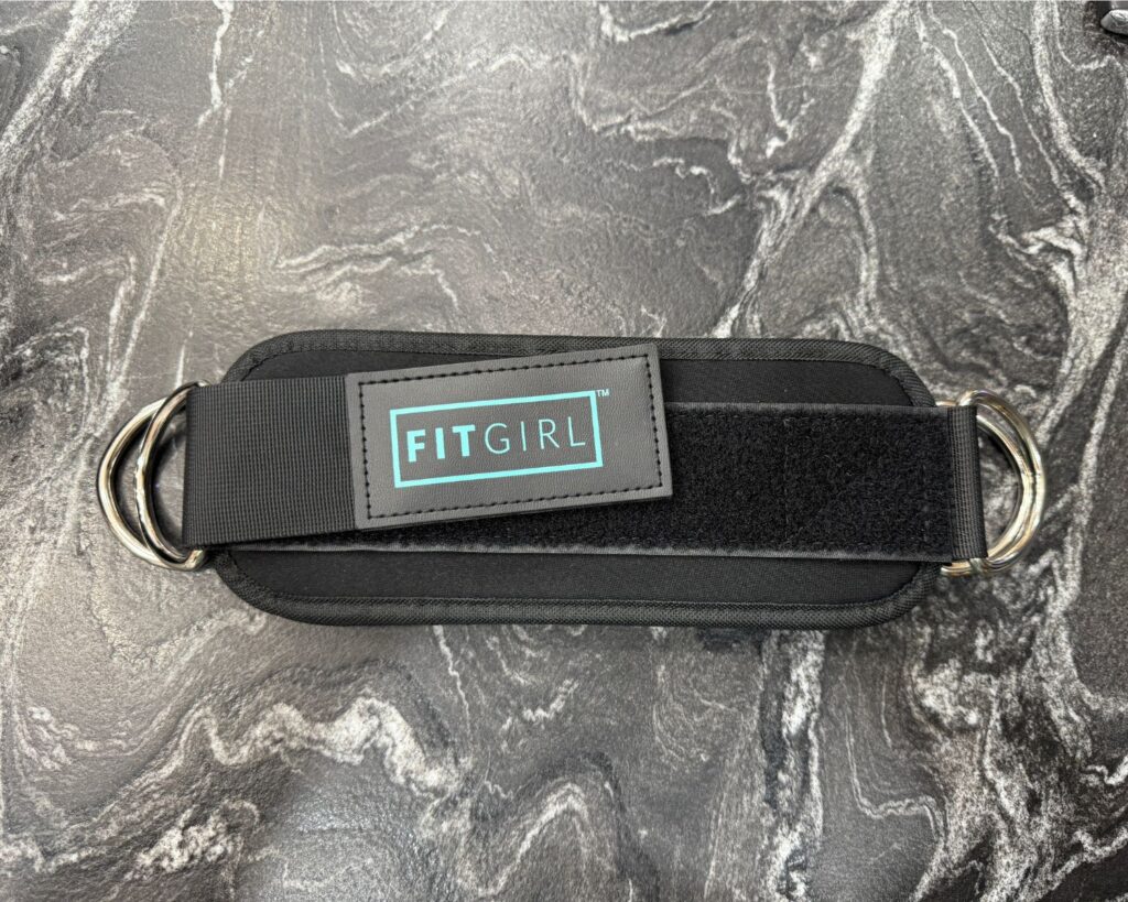 Ankle straps packed in a gym bag as a workout essential for moms