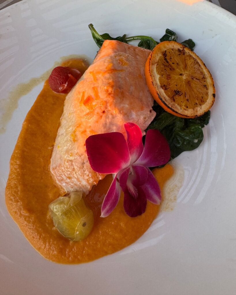 Fresh salmon dinner with citrus sauce at an oceanfront restaurant in Carlsbad California