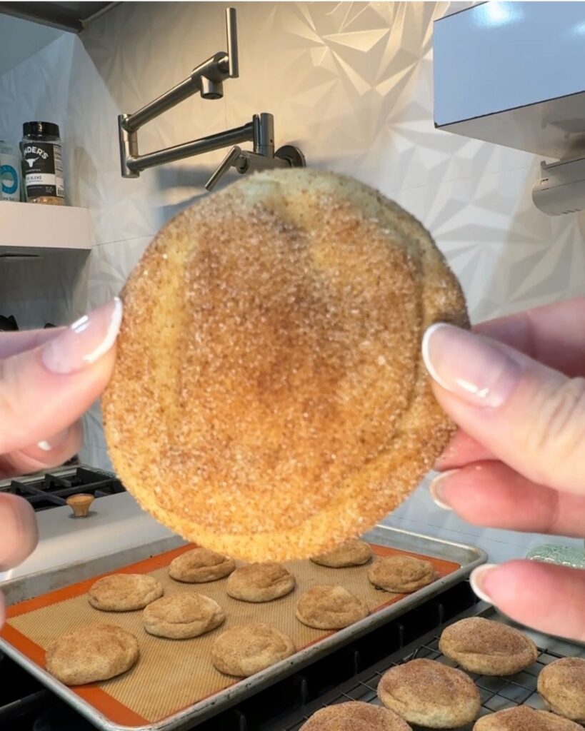 Close-up of a soft cinnamon sugar snickerdoodle cookie held by hand