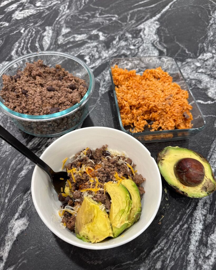 High-protein taco bowl with ground beef, rice, cheese, and avocado for an easy busy mom lunch