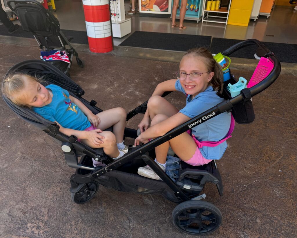 Kids riding in double stroller at LEGOLAND California theme park