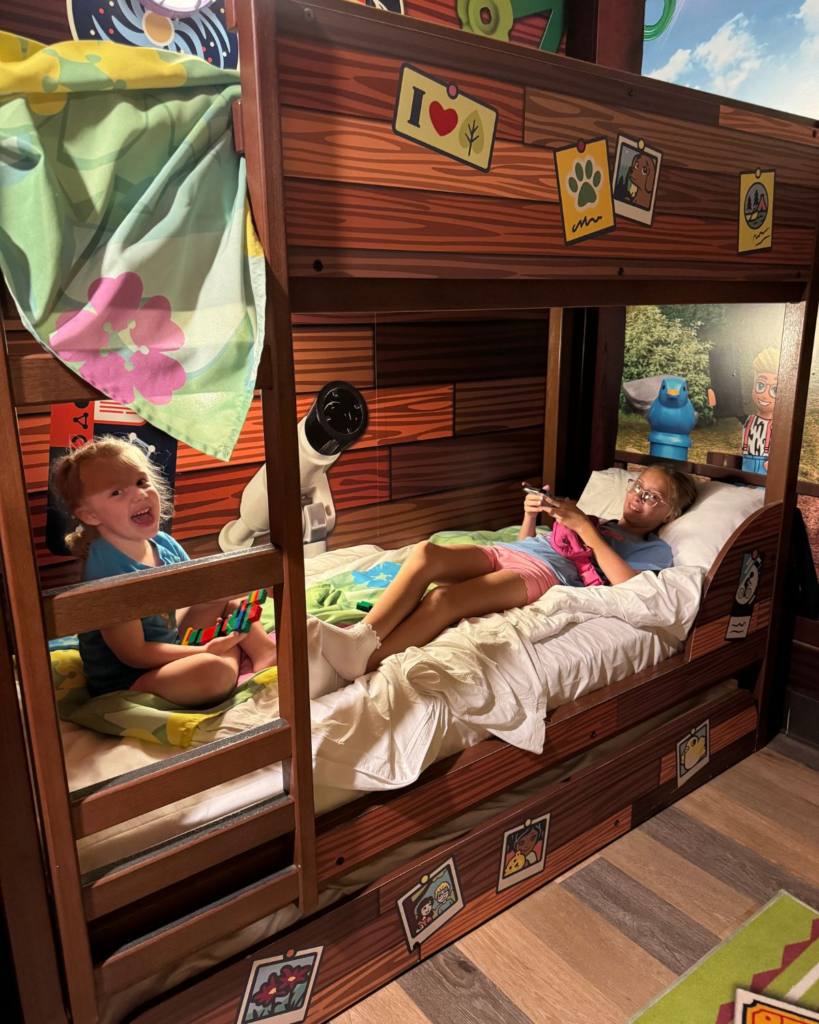 Kids relaxing in themed bunk beds inside a family room at LEGOLAND Hotel California