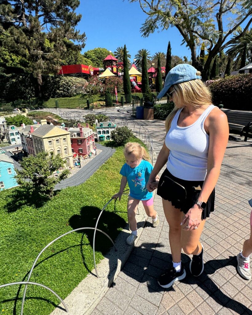 Mom and daughter walking through Miniland LEGO city display at LEGOLAND California