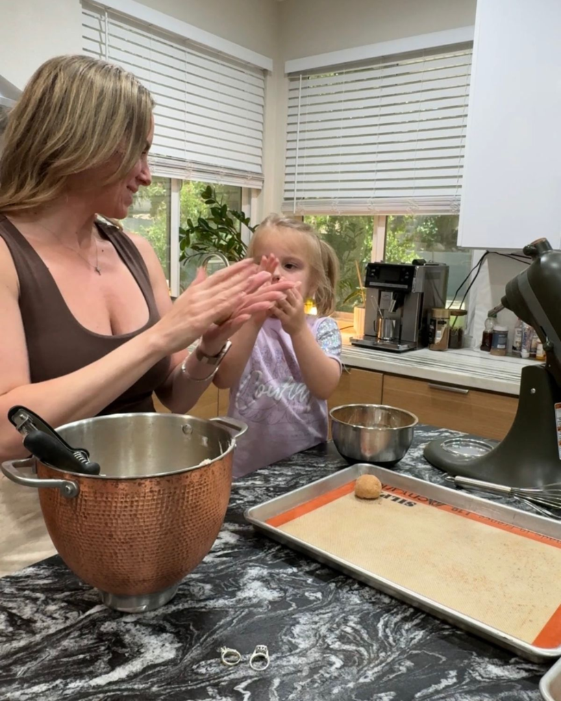 Mom and daughter shaping snickerdoodle cookie dough together