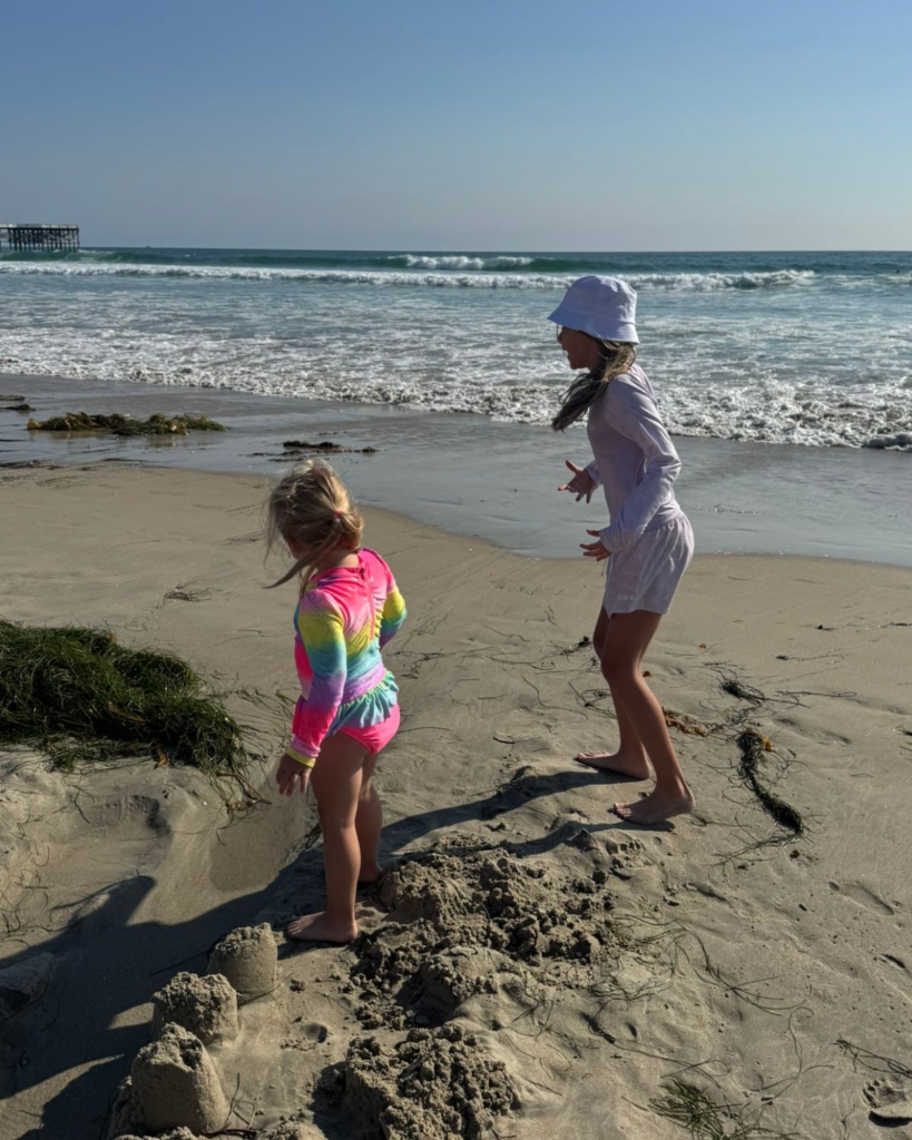 summer bucket list for families beach day with kids playing in the sand