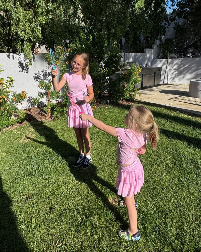 summer bucket list for families blowing bubbles outside