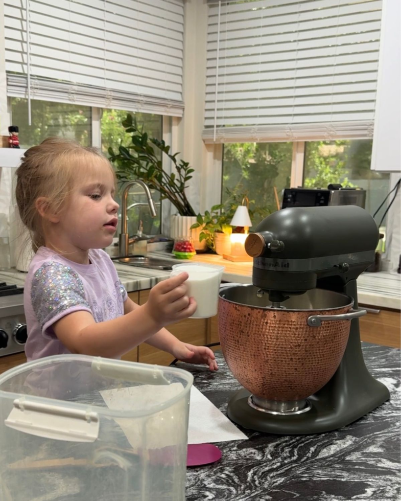 Toddler helping make homemade snickerdoodle cookie dough in a KitchenAid mixer