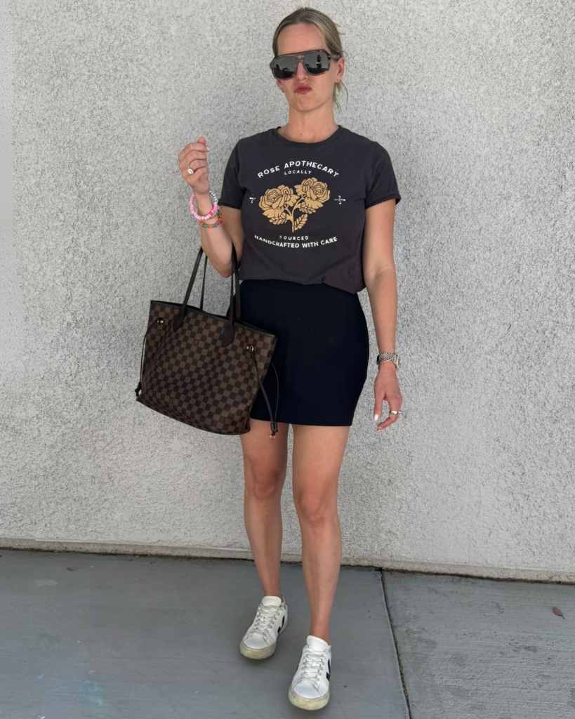 mom wearing black skort and graphic t with elevated sneakers