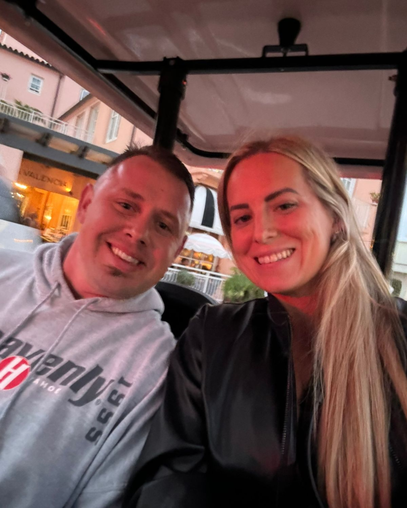 Couple riding in a golf cart at La Valencia Hotel during a anniversary trip to La Jolla.