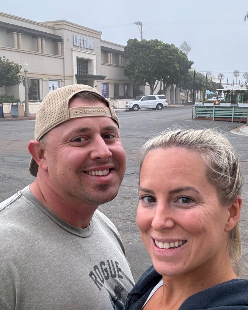 Couple taking a selfie outside Lifetime Fitness during a foggy morning in La Jolla.