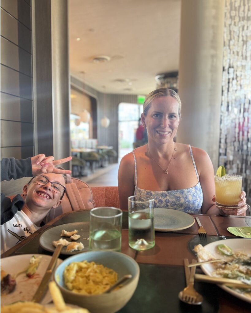 Family dinner at Paradisaea restaurant in La Jolla featuring the “Bruce Wayne It” margarita, pasta dishes, and kids enjoying an upscale coastal California meal together.