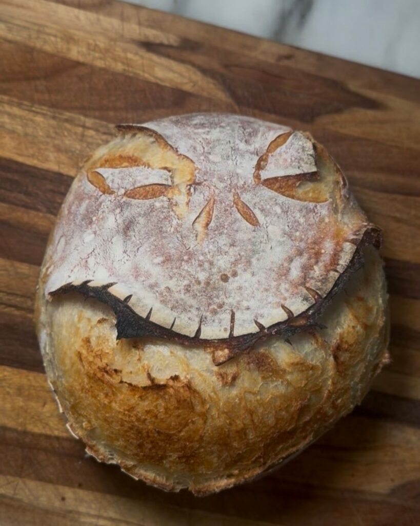 Decorative Jack Skellington sourdough bread created with artistic scoring techniques.