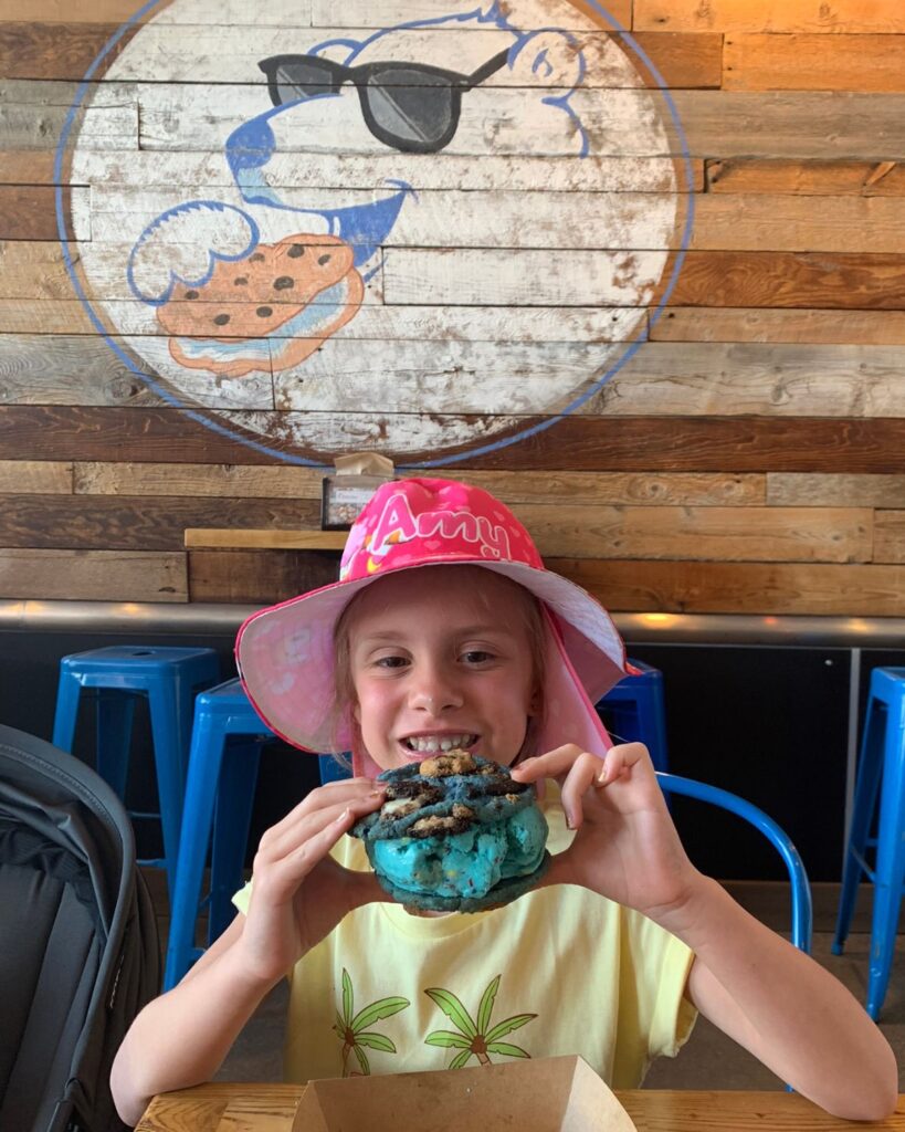 girl eating ice cream and cookie sandwich at the baked bear