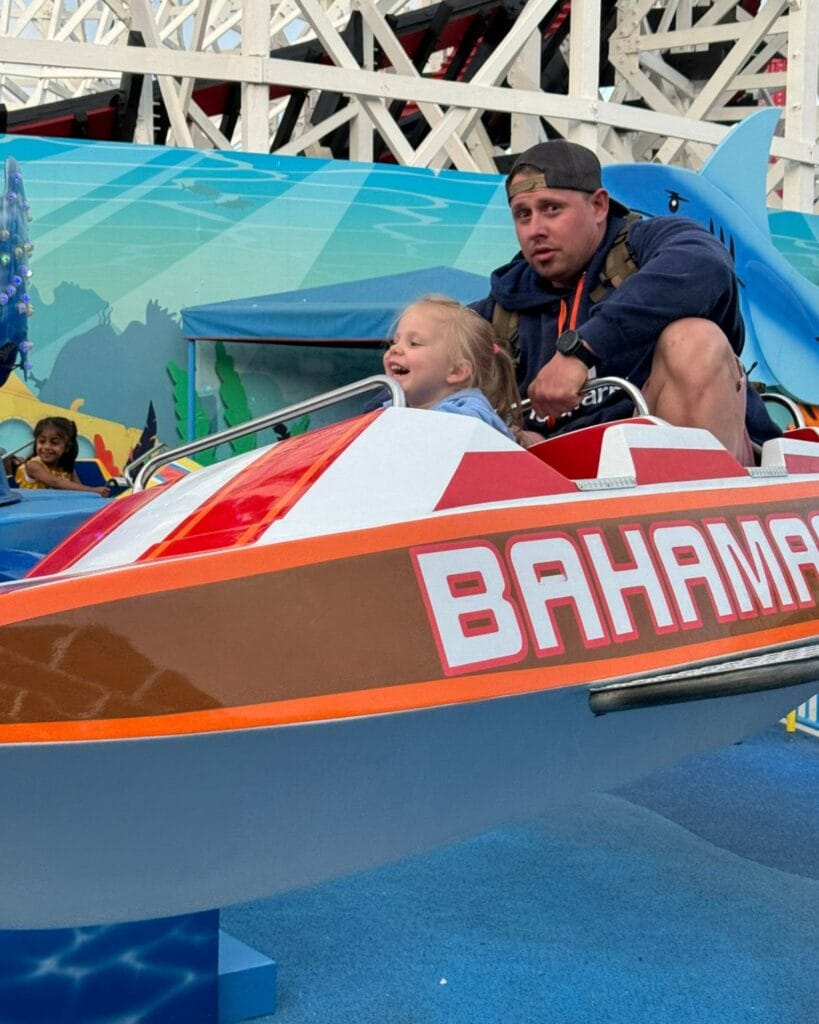 dad with daughter on a ride in belmont park