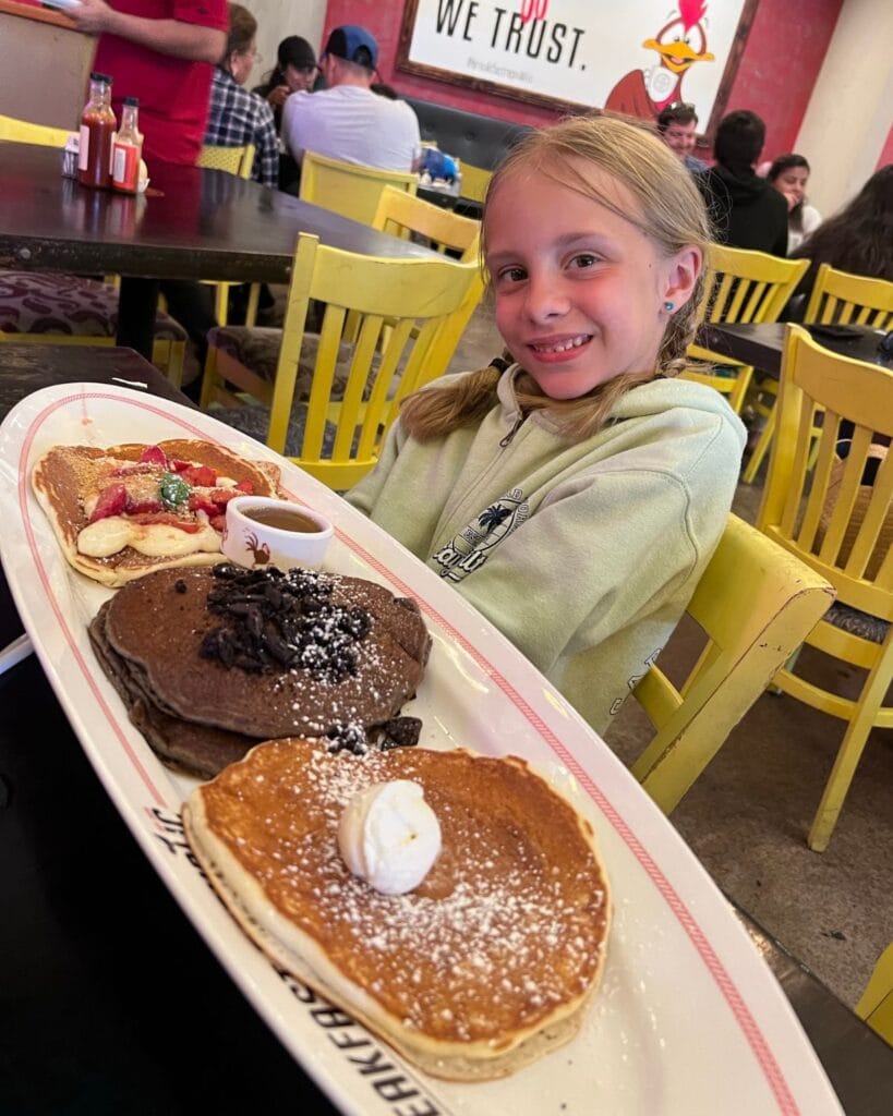 girl eating a pancake flight at breakfast republic in pacific beach