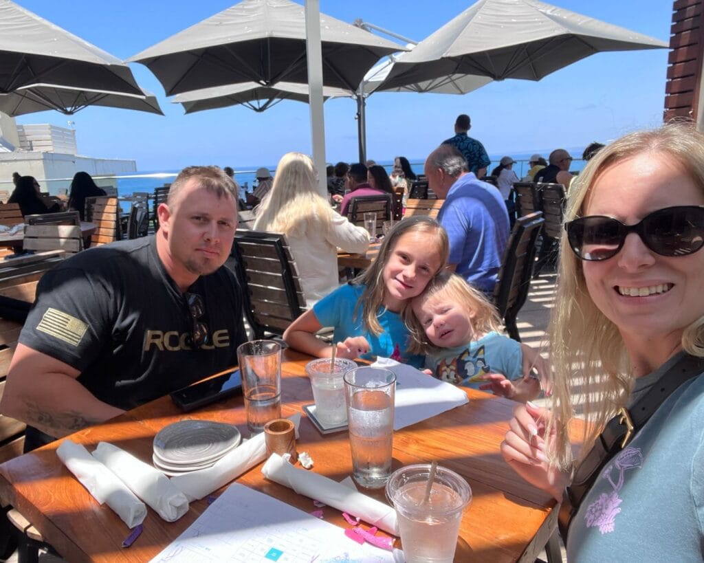 family eating on the patio of dukes la jolla for lunch