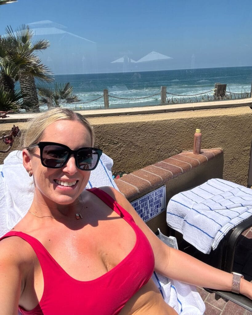 a mom sitting poolside at pacific terrace in pacific beach