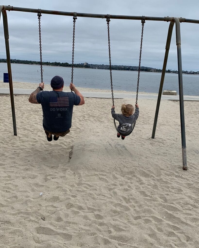 dad and daughter swinging by mission bay