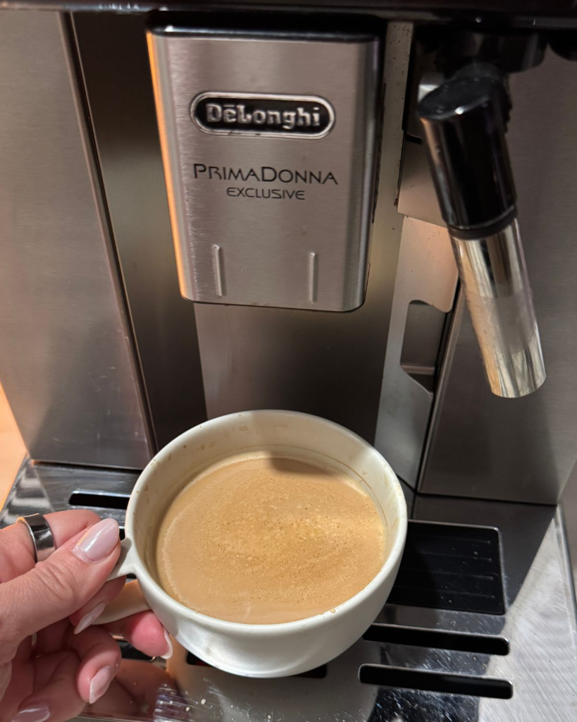 delonghi primadonna exclusive coffee machine with a fresh cup of coffee