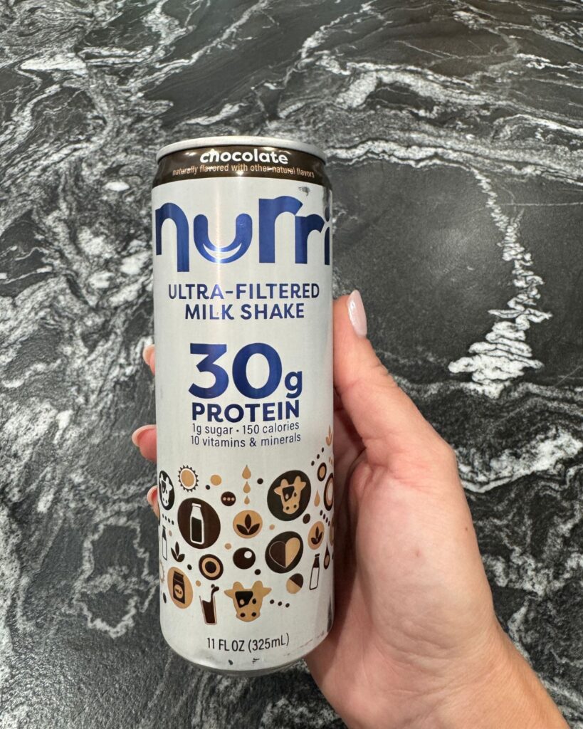 chocolate nurri protein shake in moms hand as part of the simpe mom routine