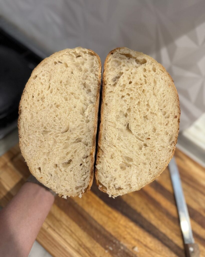 Inside view of homemade sourdough bread showing the crumb structure after baking.