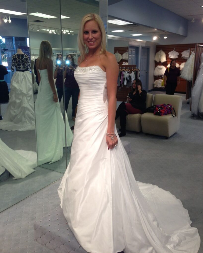 Julie trying on a wedding dress before getting breast implants at age 24.