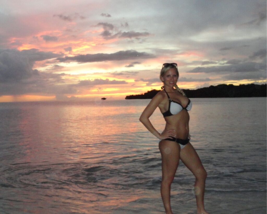 Julie enjoying the sunset on her honeymoon in Jamaica during the early years with breast implants.