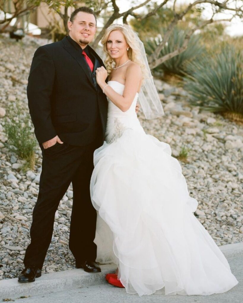 Julie and her husband on their wedding day after her first breast augmentation.