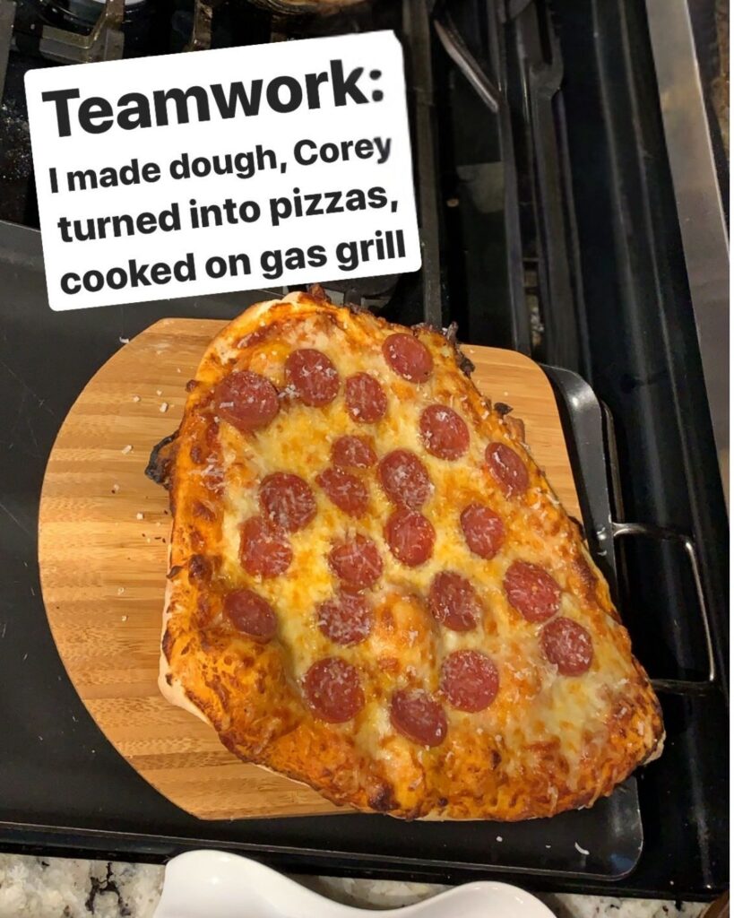 Homemade pepperoni pizza made with easy sourdough pizza dough after cooking on a pizza stone on the grill.