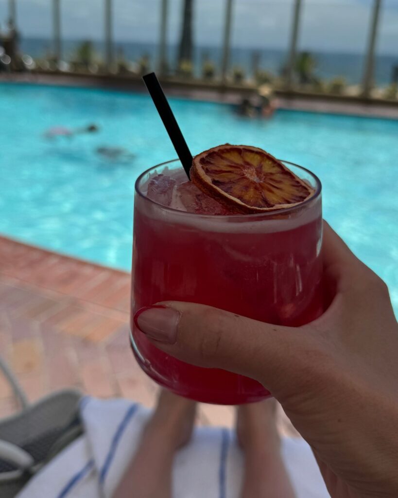 Blood orange margarita by the pool overlooking the ocean at Pacific Terrace Hotel.
