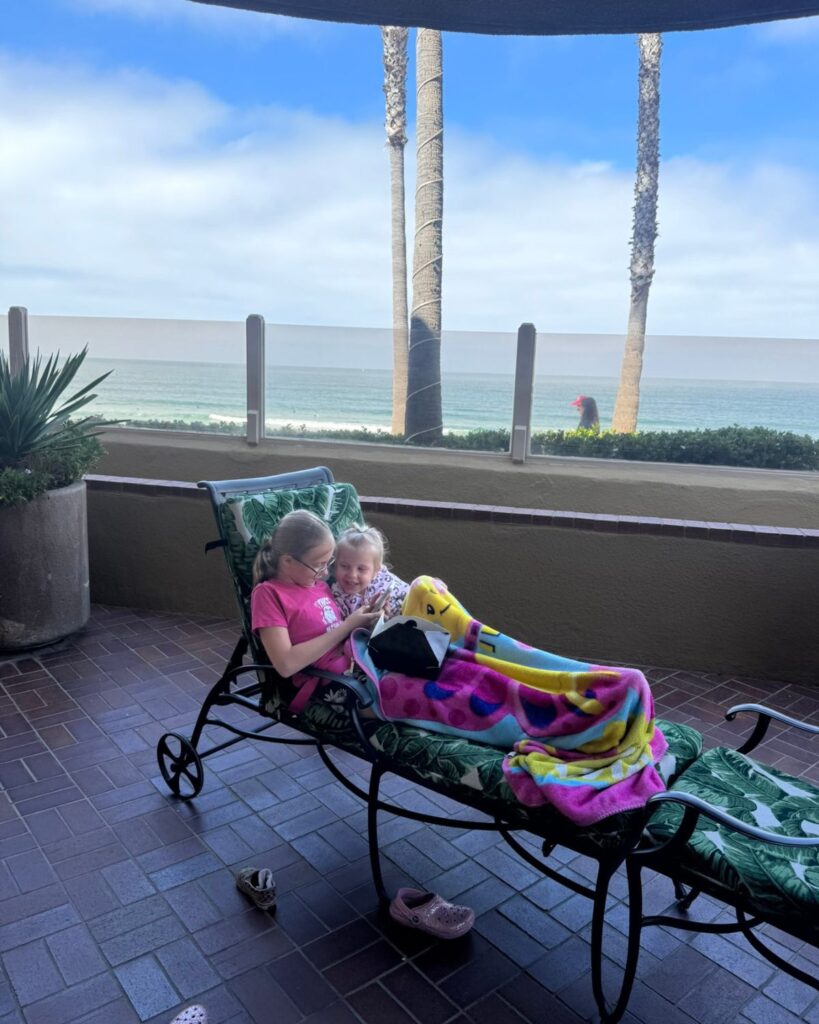 Sisters relaxing together on the private patio outside their Family Suite.