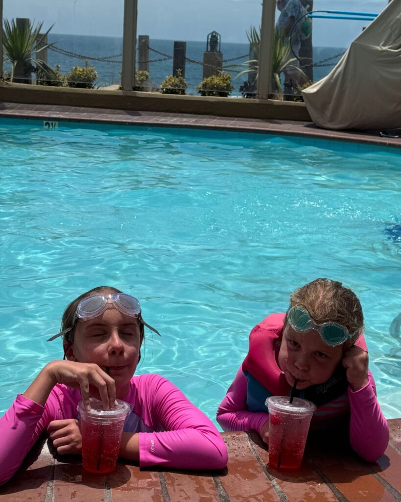 Girls enjoying Shirley Temples in the pool at Pacific Terrace Hotel.
