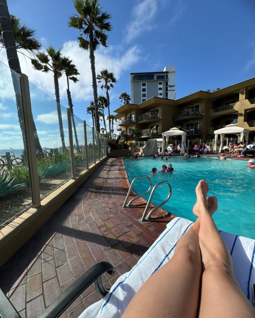 Poolside lounge chair with views of the Pacific Ocean at Pacific Terrace Hotel.