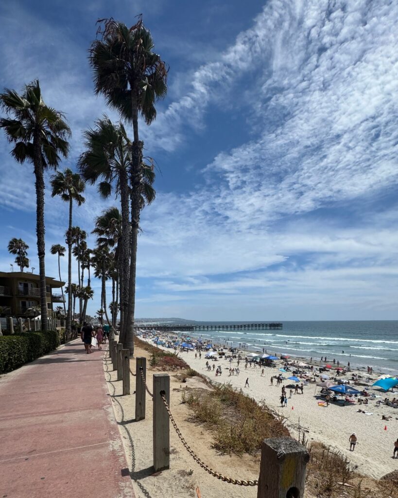 View of the Pacific Beach boardwalk and Pacific Terrace Hotel overlooking the beach.