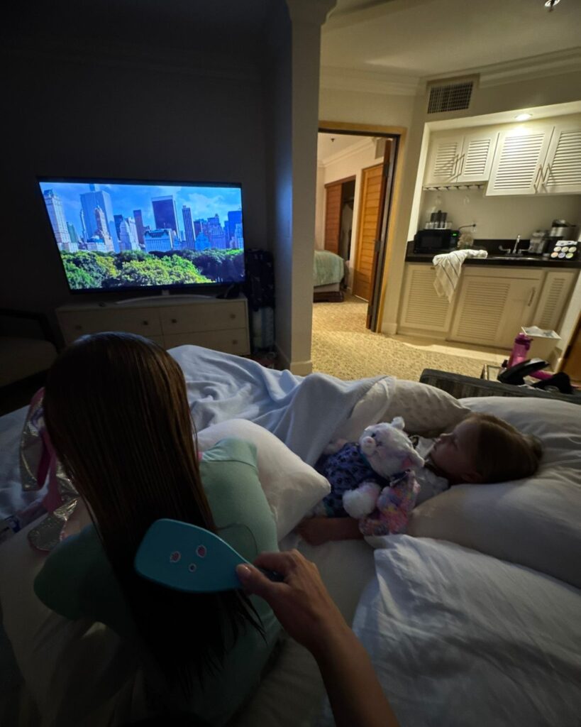Kids relaxing and watching TV inside the Family Suite at Pacific Terrace Hotel.