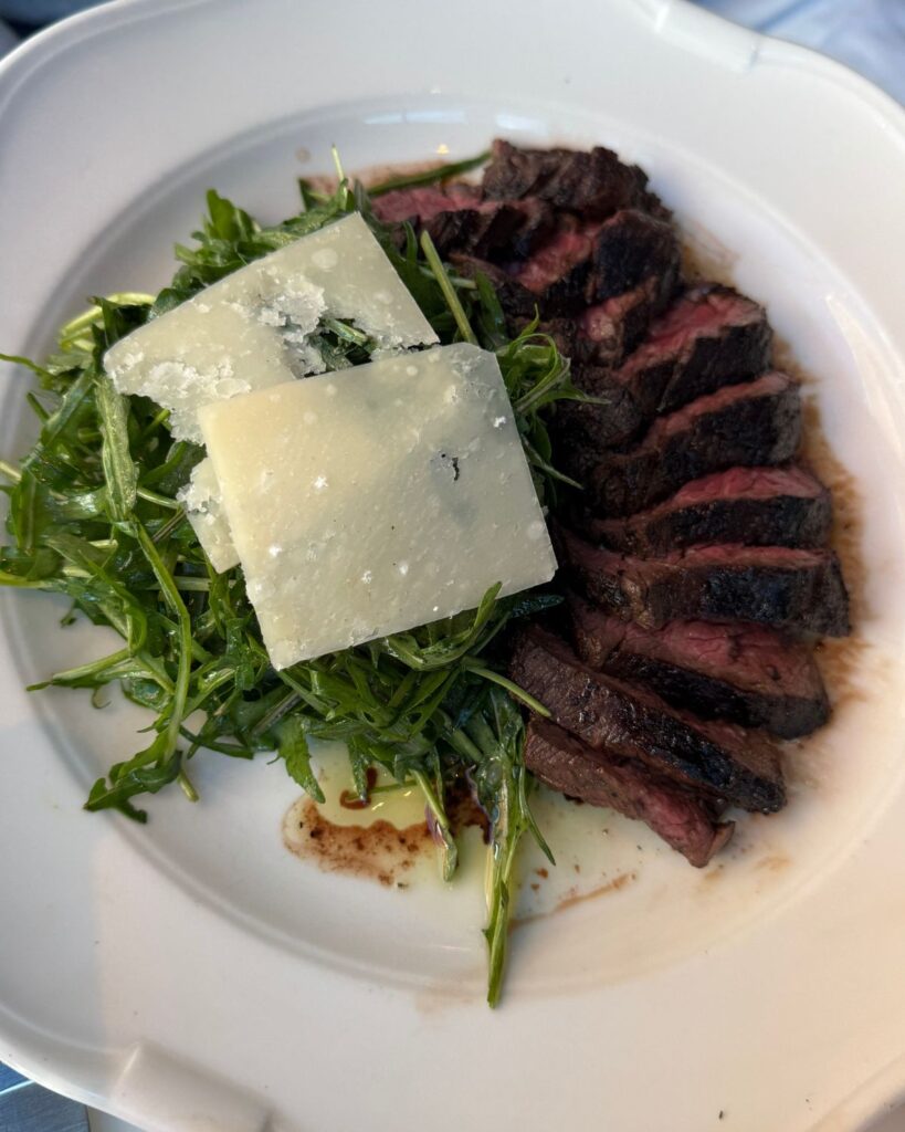 Steak with arugula served at Osteria Mozza in Washington DC.