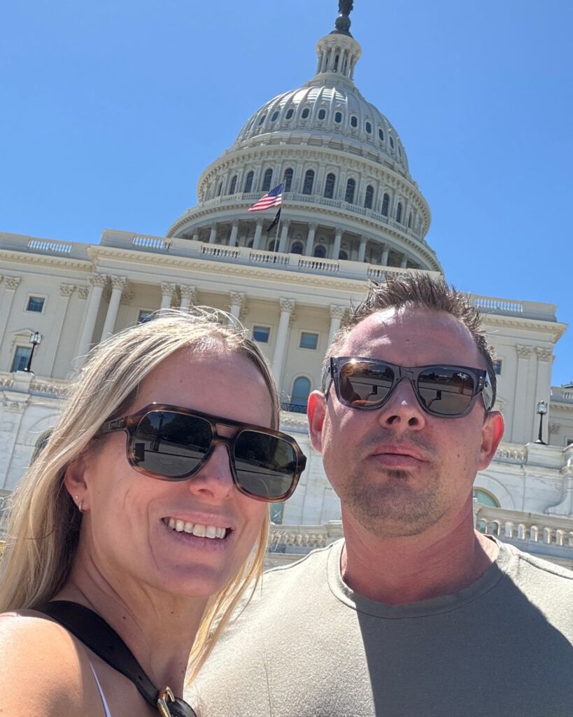 Couple posing in front of the United States Capitol Building in Washington DC.