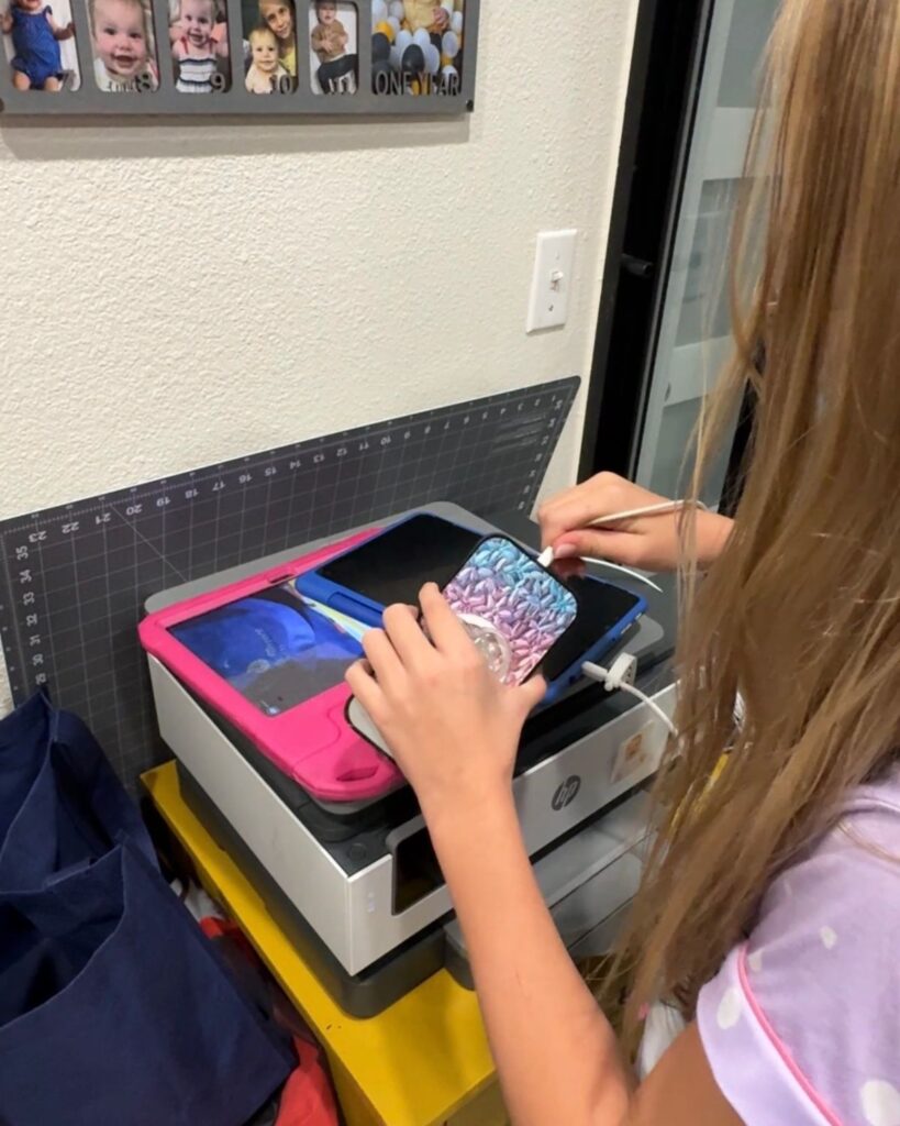 Elementary school student plugging in her school devices during the night-before routine