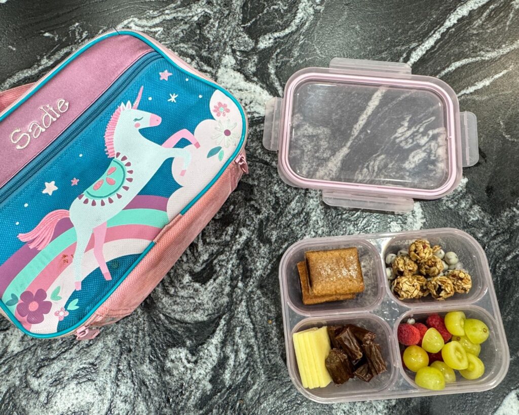 Packed school lunch with a sandwich, fruit and snacks ready for the next day