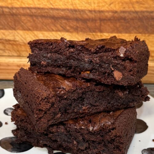 Stack of thick fudgy brownies made with Ghirardelli brownie mix, butter, and chocolate chips.